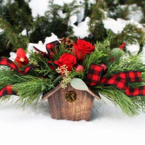 winter greenery, flowers, and christmas accents in wood birdhouse