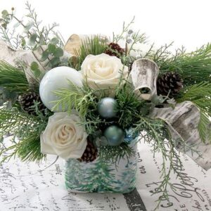 Christmas greenery, pine boughs, cedar, carolina saphire, white roses, white flowers, birch ribbon, in winter ceramic vase